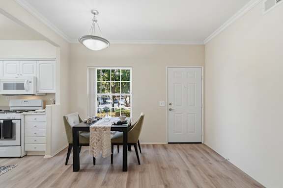 A dining room with a table set for two.