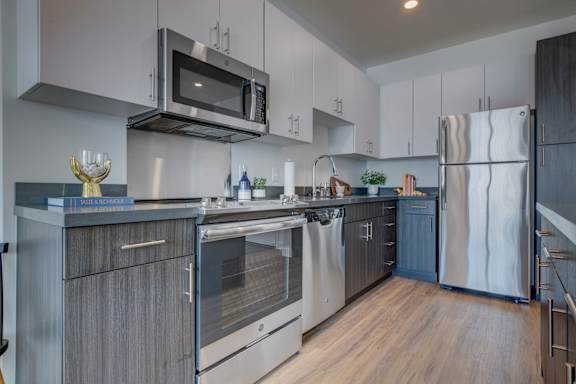 A modern kitchen with a stainless steel oven and microwave.