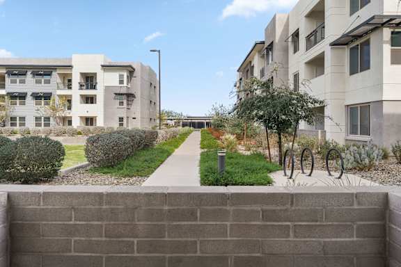 A modern apartment complex with a bicycle parked in front.