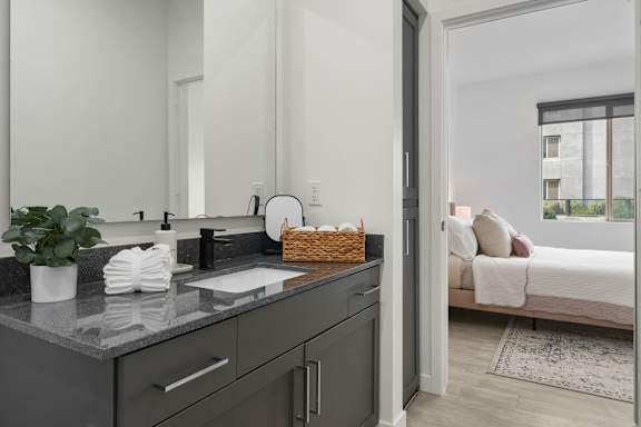 A kitchen with a sink and a mirror.
