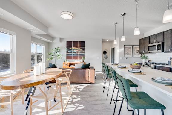 A modern kitchen with a dining table and chairs.