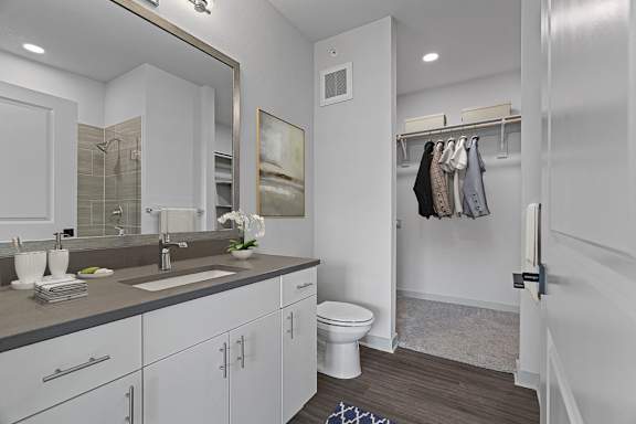 A bathroom with a white toilet and a white sink.