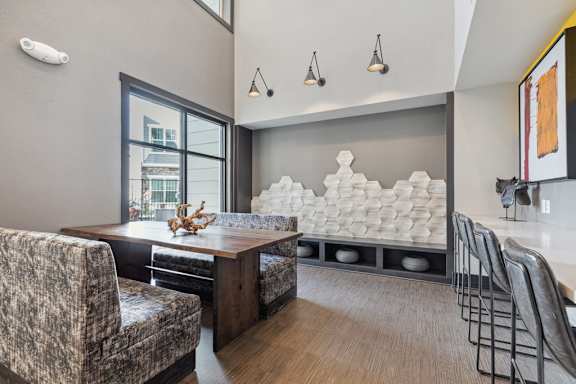 A modern dining room with a wooden table and chairs.