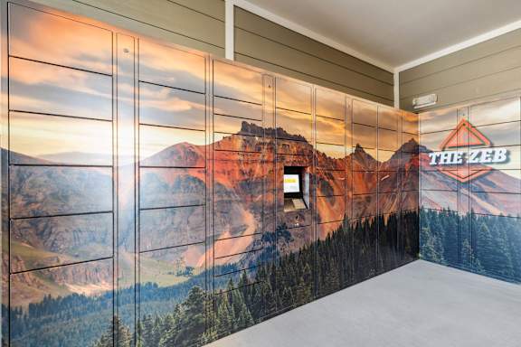 A wall mural depicting a mountain scene with the text