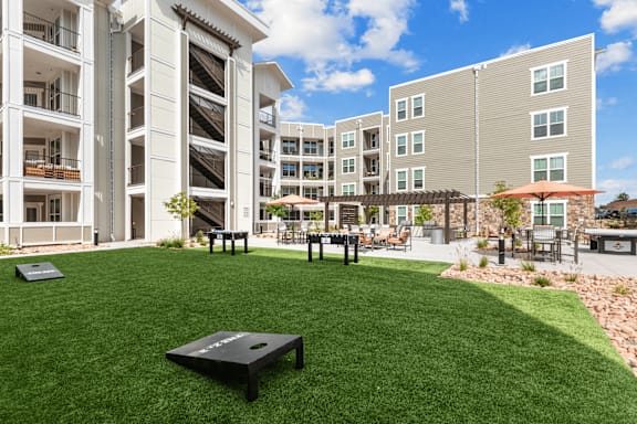 A large grassy area with a black table in the middle of it.