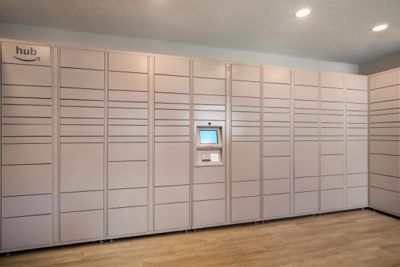 a row of white lockers in a room with a wood floor at View at Lake Lynn, Raleigh, NC