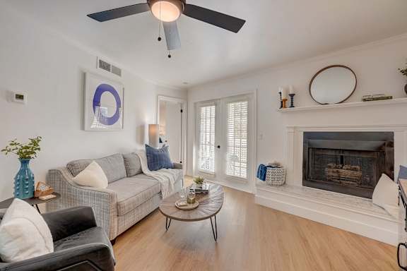 A living room with a grey couch, a coffee table, and a fireplace.
