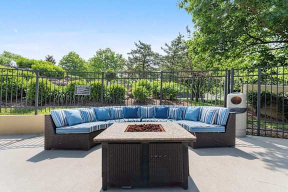 A patio with a sofa, table and a sign.