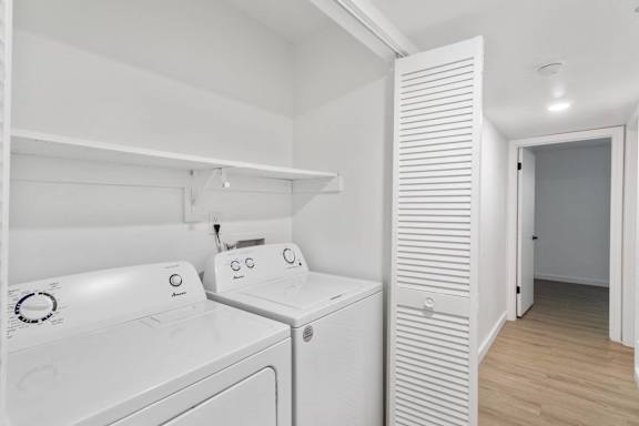 A white washing machine and dryer in a small laundry room.