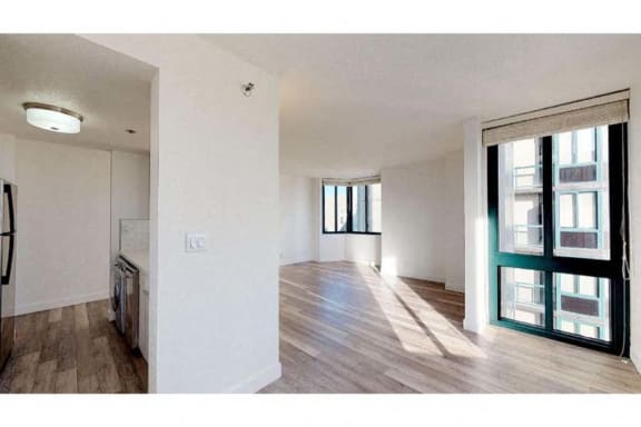 a living room with a large window and a wooden floor