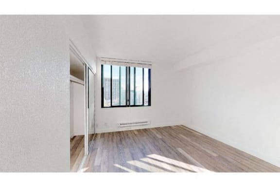 an empty room with a window and a door