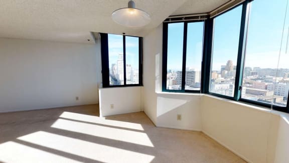 an empty room with a large window and a view of the city