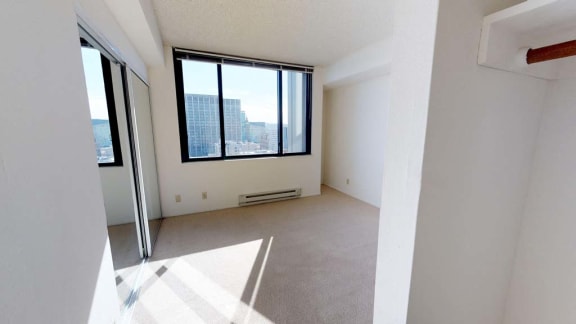 an empty room with a large window and a door