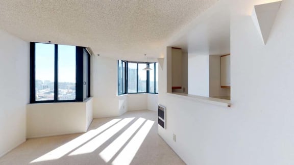 an empty room with a large window and a radiator