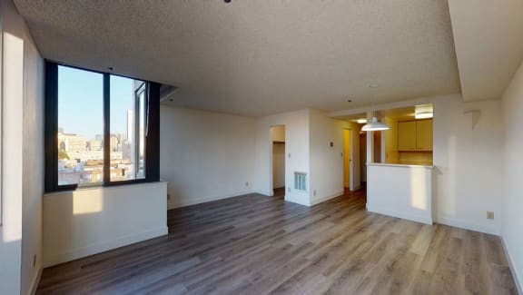an empty living room with a large window