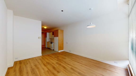 a room with a wooden floor and white walls