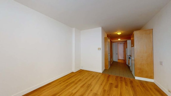 a room with a wooden floor and white walls
