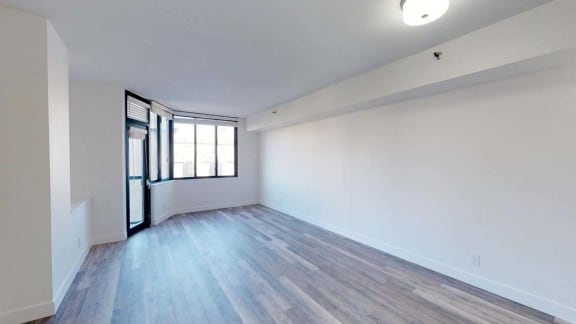 an empty room with hardwood floors and white walls