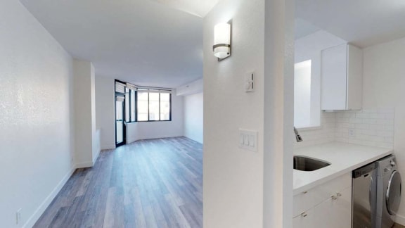 an empty room with a sink and a washing machine