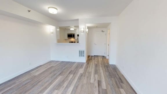 an empty room with white walls and a wooden floor