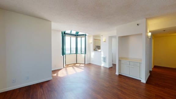 an empty living room with a door to a balcony