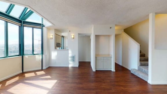 an empty living room with a large window