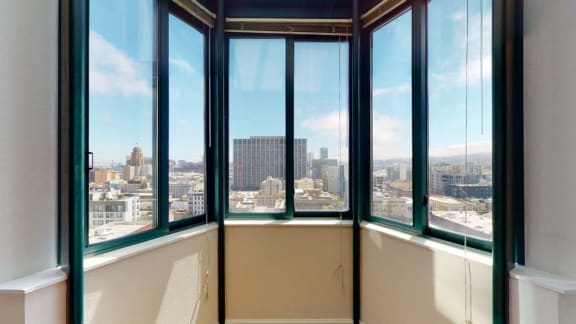 a room with many windows and a view of the city