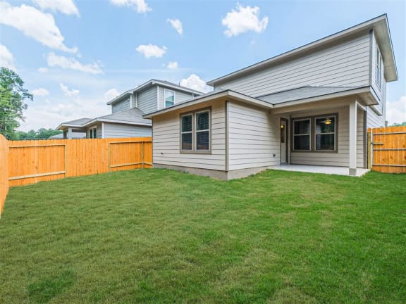 a house with a yard and a wooden fence