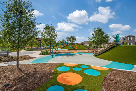 a park with a playground and trees at The Village at Caney Mills, Conroe, TX, 77303