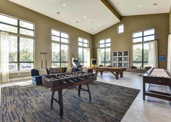 a game room with a foosball table and a pool table