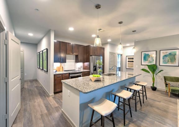 a kitchen with a large island with stools