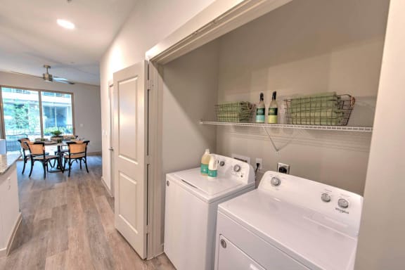 a washer and dryer in a laundry room next to a dining room table
