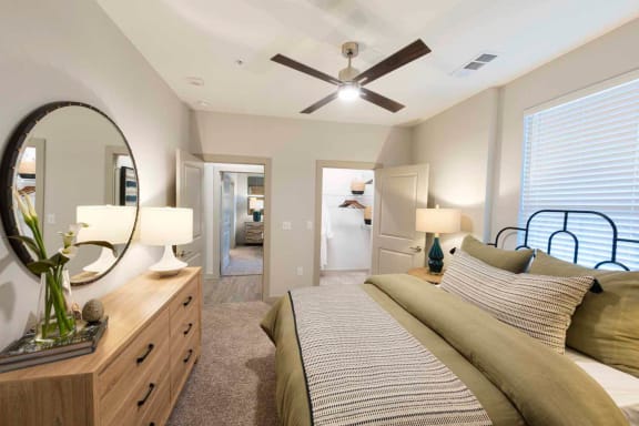 a bedroom with a bed and a ceiling fan