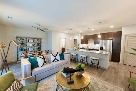a living room and kitchen with a couch and a table