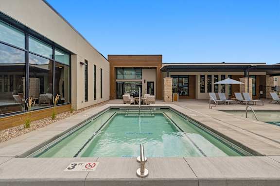 A swimming pool with a height restriction sign.