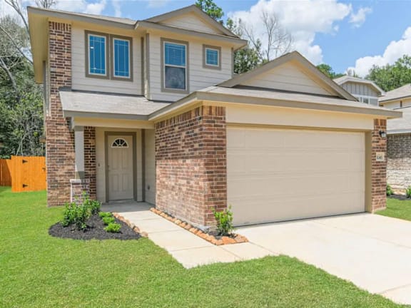 A house with a grey roof and a white garage door.