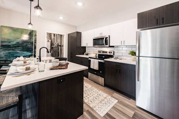 a kitchen with stainless steel appliances and a marble counter top