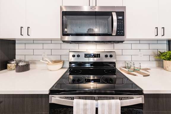 a kitchen with a stove and a microwave above it