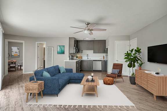 A living room with a blue couch and a wooden coffee table.