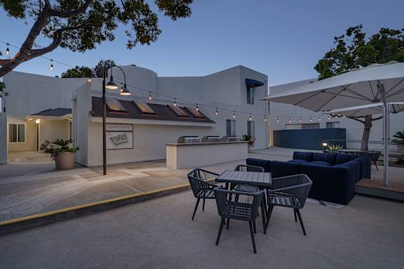 A patio with a table and chairs is set up outside a building.