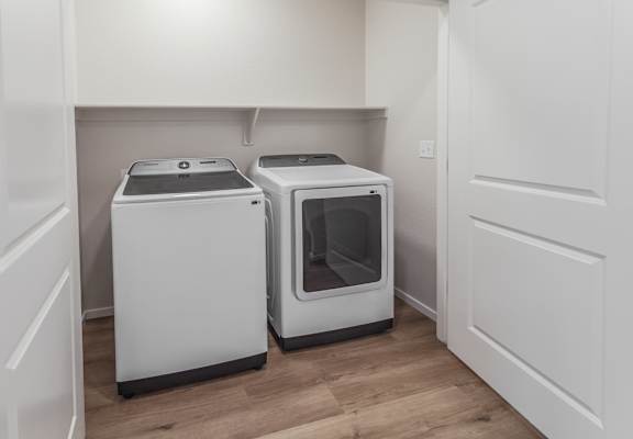 A white dishwasher and microwave in a kitchen.