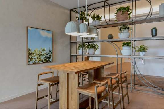 A dining area with a wooden table and chairs.