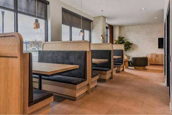A modern dining area with wooden furniture and a large window.