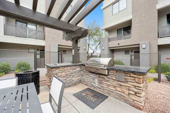 A BBQ zone is located in the courtyard of a residential building.