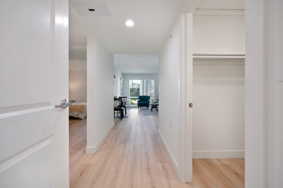 a bedroom with a medium sized bed and a chair in a room with a desk and a at Citrus Heights Apartments, Citrus Heights, CA