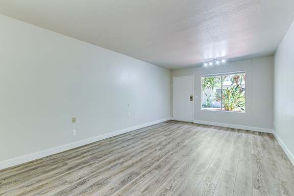 Floor Plan  Empty room with wooden flooring and a window.