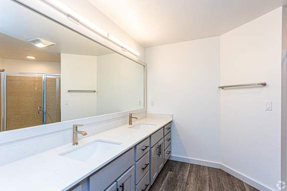 A bathroom with a white counter top and a large mirror at 128 on State, Kirkland, WA, 98033