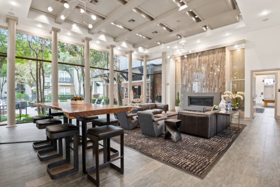 a living room with a large table and a fireplace
