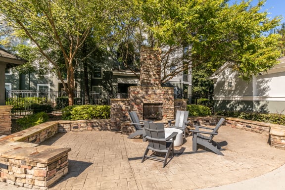 a patio with a table and chairs and a brick fireplace at Deerfield Village, Alpharetta, Georgia