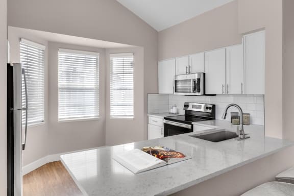 Kitchen with breakfast bar at The Links at Plum Creek in Castle Rock, CO